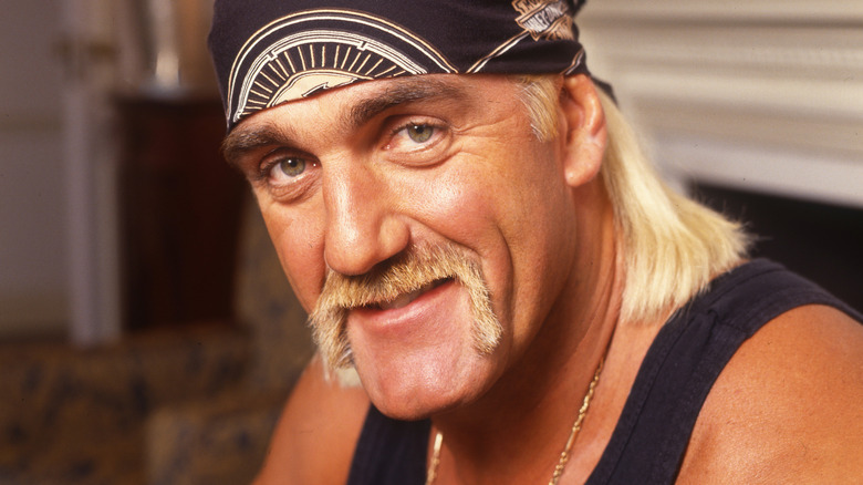 Hulk Hogan in black bandanna and tank tap
