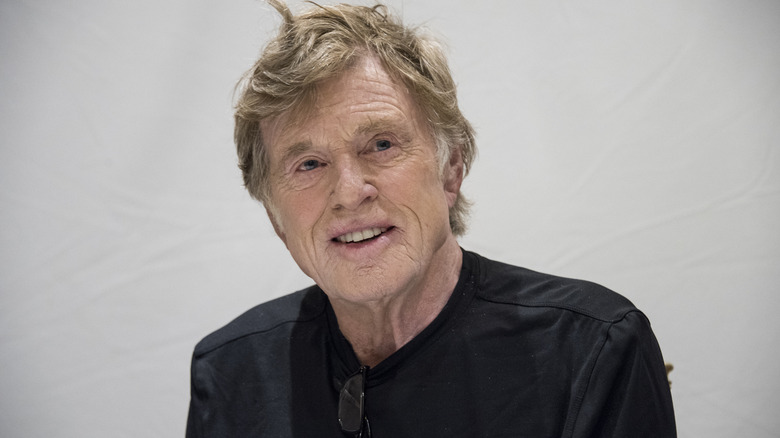 Robert Redford smiling at a press conference in 2018