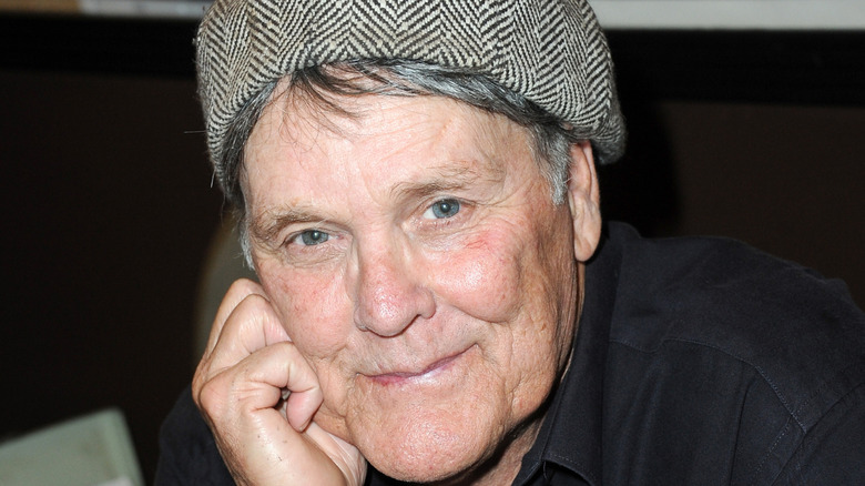 Wings Hauser posing with hat on