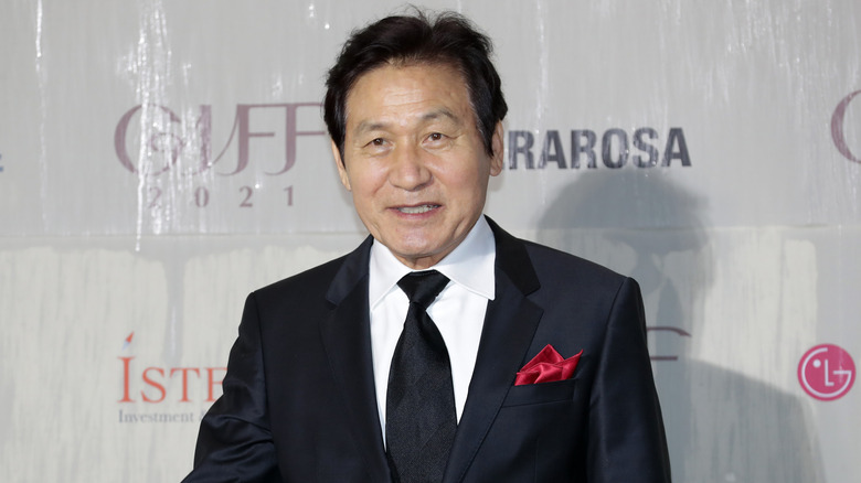 Ahn Sung-ki in a black suit and tie