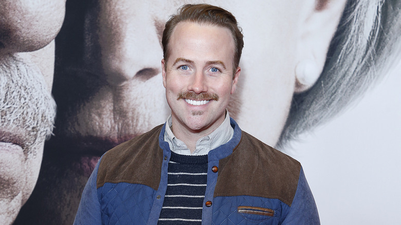 Bret Shuford smiling in a blue and brown jacket