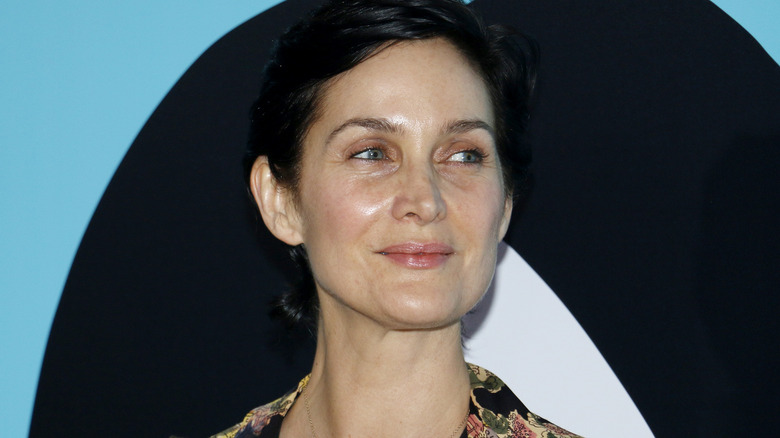 Carrie-Anne Moss smiles