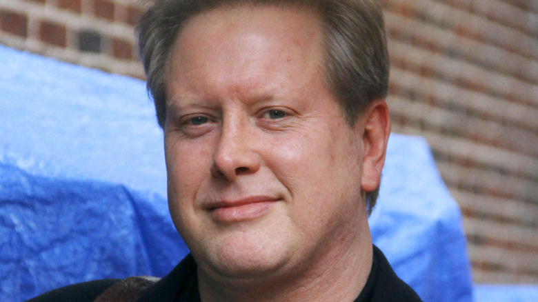 Darrell Hammond in front of tarp
