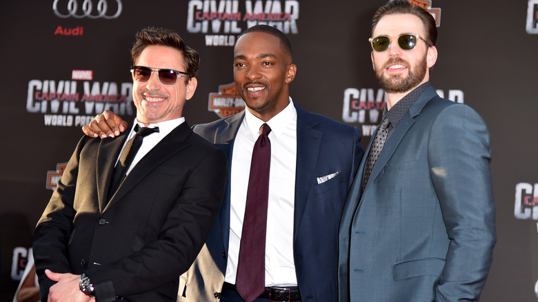 Robert Downey Jr., Anthony Mackie, and Chris Evans smiling at 