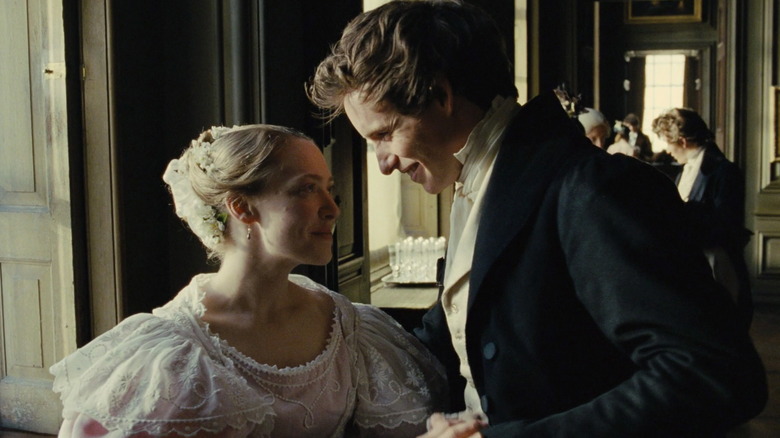 Cosette and Marius smiling at each other 