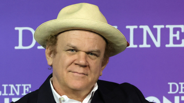John C. Reilly solemn in hat