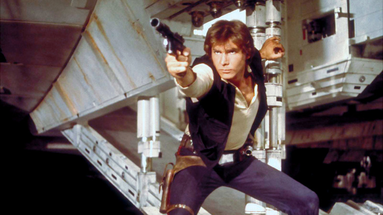 Han Solo shoots his blaster beneath the Millennium Falcon in Star Wars (1978)