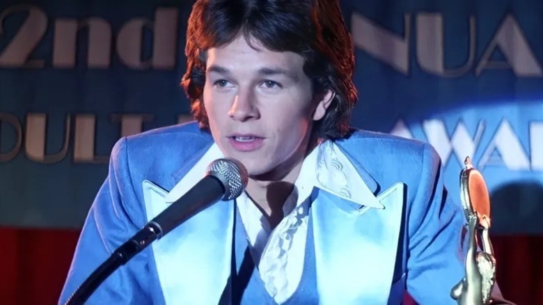 Dirk Diggler in blue suit talking into microphone in Boogie Nights (1997)