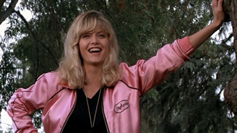 Stephanie Zinone leans against a tree laughing in Grease 2 (1982)