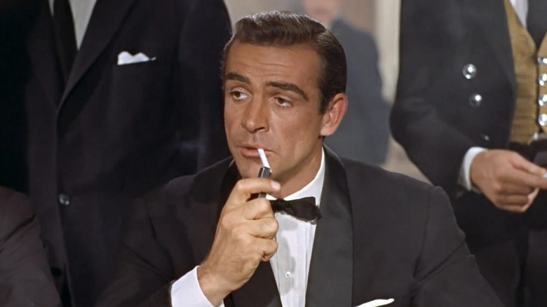 James Bond lights a cigarette in Dr. No (1963)