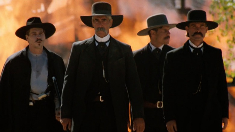 Tombstone group walks in front of fire