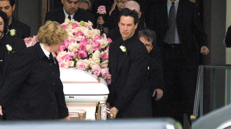 Keanu Reeves carries a coffin