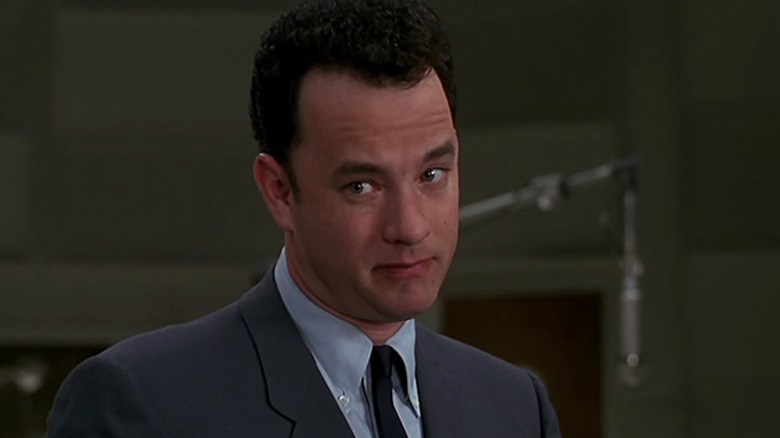 Tom Hanks looks left in a suit