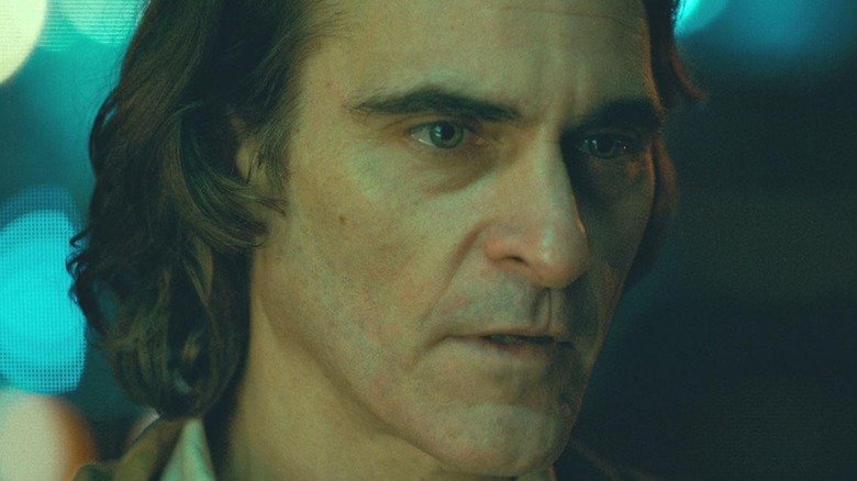 Joaquin Phoenix as Arthur Fleck in close-up, staring to the right