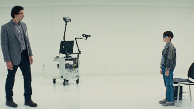 Sevier in a white room, facing Alton in his blue glasses, in "Midnight Special" (2016)