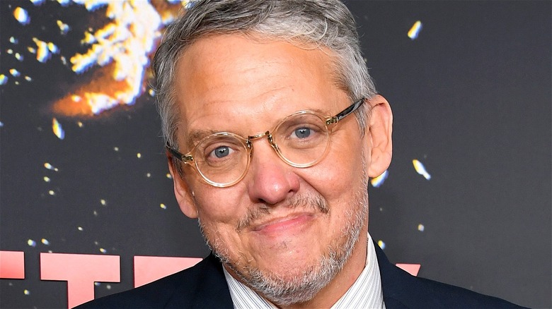 Adam McKay smiling at a red carpet event