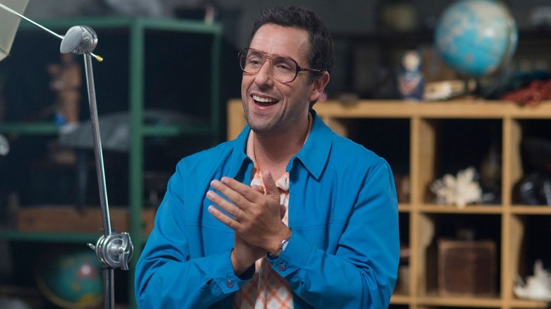 Adam Sandler on his feet applauding
