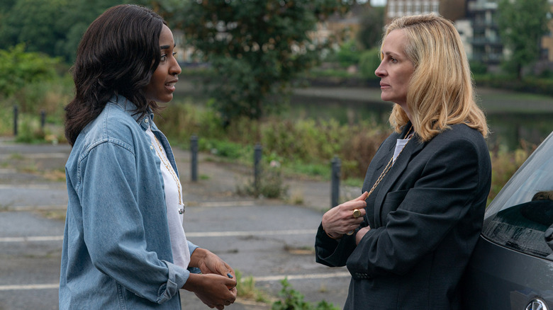 Maggie and Alma stand in a parking lot in "After the Hunt" (2025)