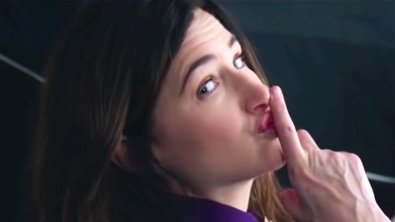 Agatha making "shh" gesture