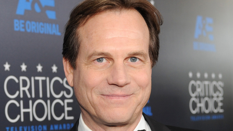 Bill Paxton, wearing black tie, smiles for the camera