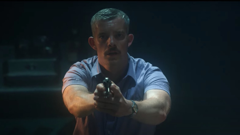 Patrick pointing his gun