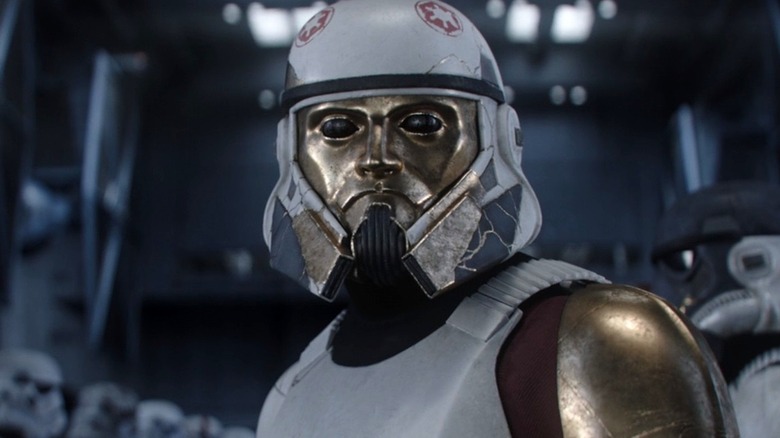 Enoch wearing gold Storm Trooper helmet 