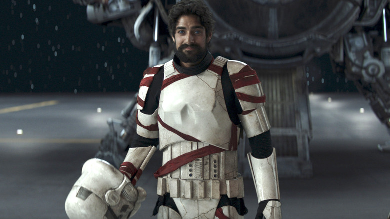 Ezra Bridger holds stormtrooper helmet