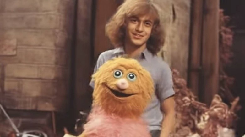 Person posing with puppet character