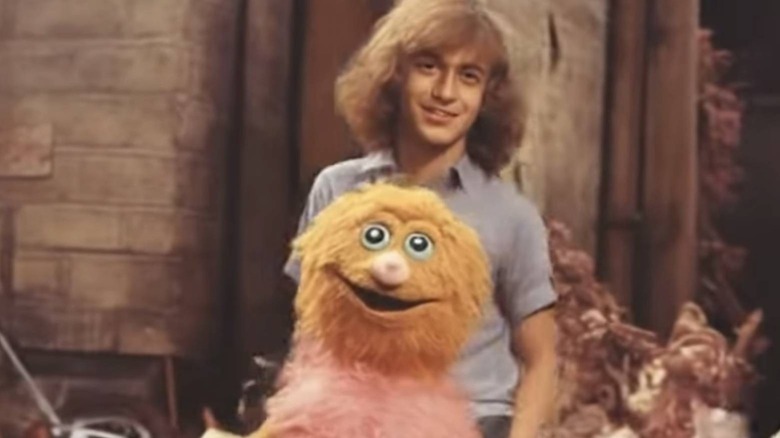 Person posing with puppet character