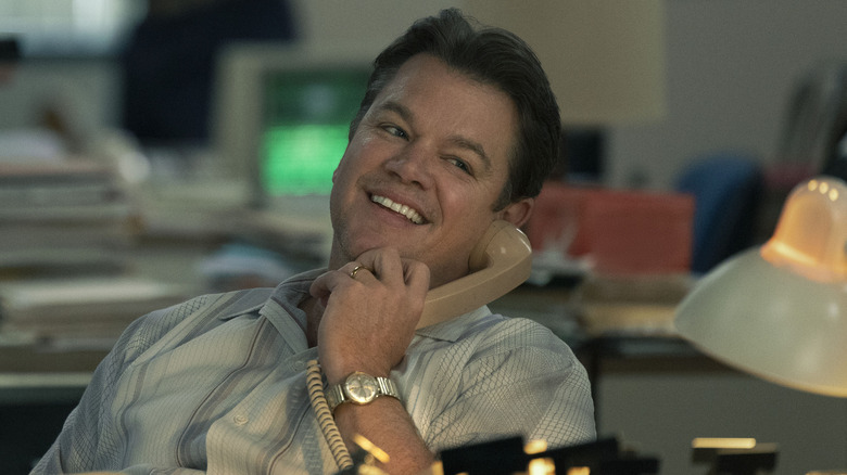 Matt Damon smiling at desk