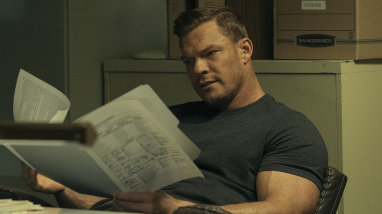 Reacher reading papers