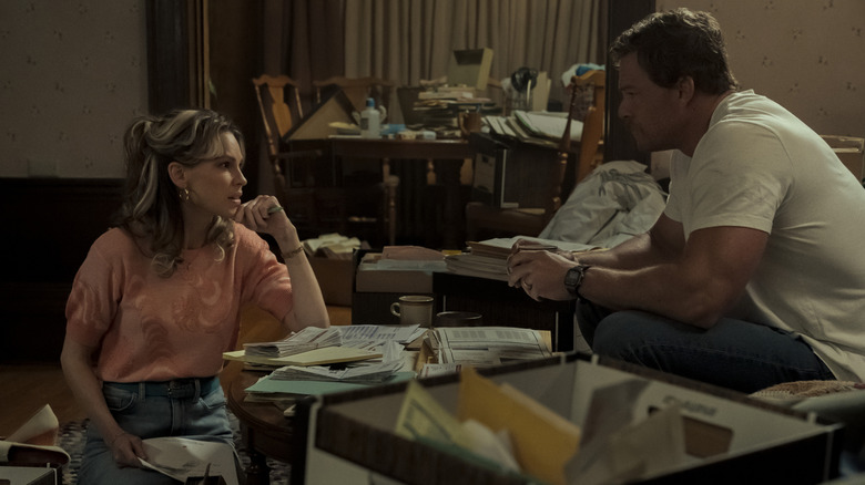 Sharon and Ed talking surrounded by paperwork in Ordinary Angels