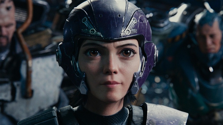 Alita standing in front of fighters in 