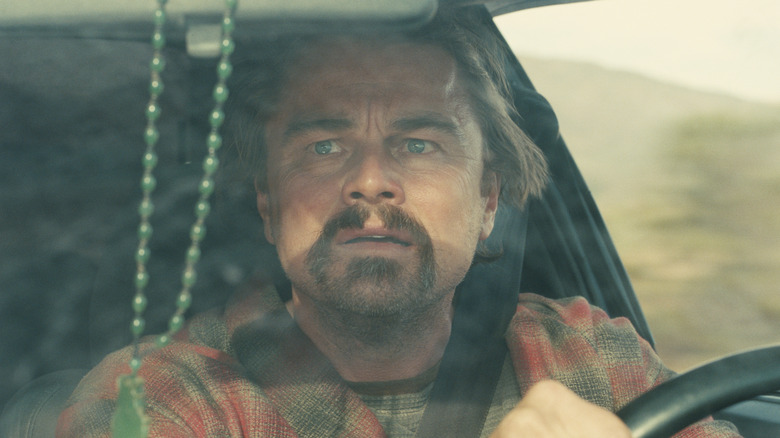 Bob behind the wheel of his car in "One Battle After Another" (2025)
