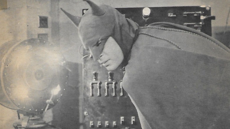 Batman inspecting a weird device in Batman (1943)