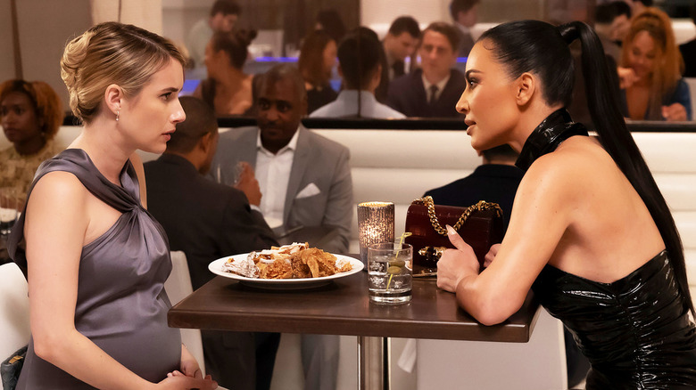 Anna Alcott and Siobhan Corbyn dish at dinner in "American Horror Story: Delicate"