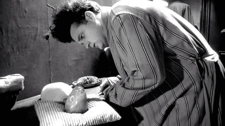Henry cares for his baby in "Eraserhead" (1977)