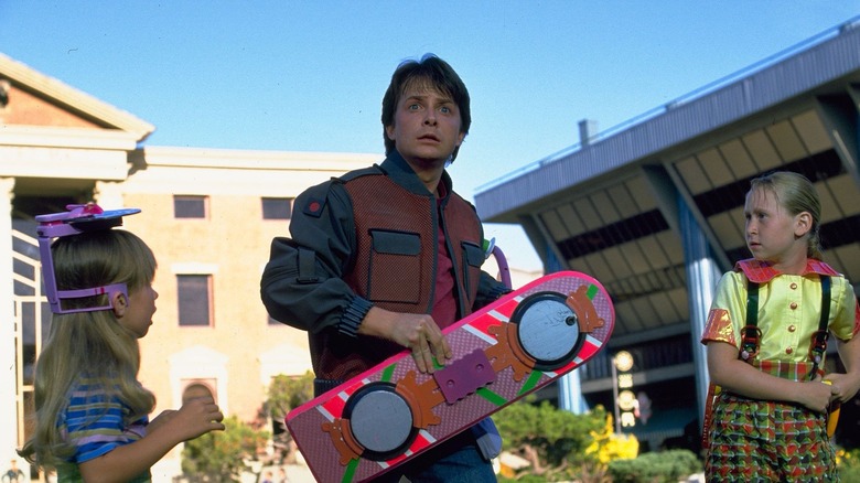 Marty McFly clutching a hover-board in Back to the Future: Part II (1989)