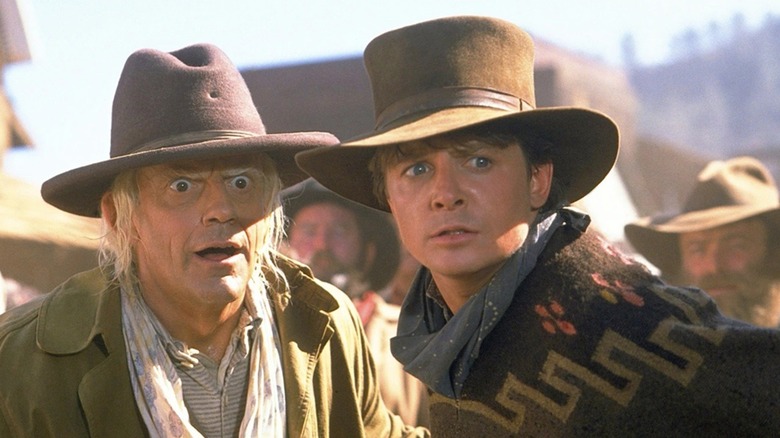 Doc Brown and Marty McFly looking around urgently in the old West in Back to the Future: Part III (1990)