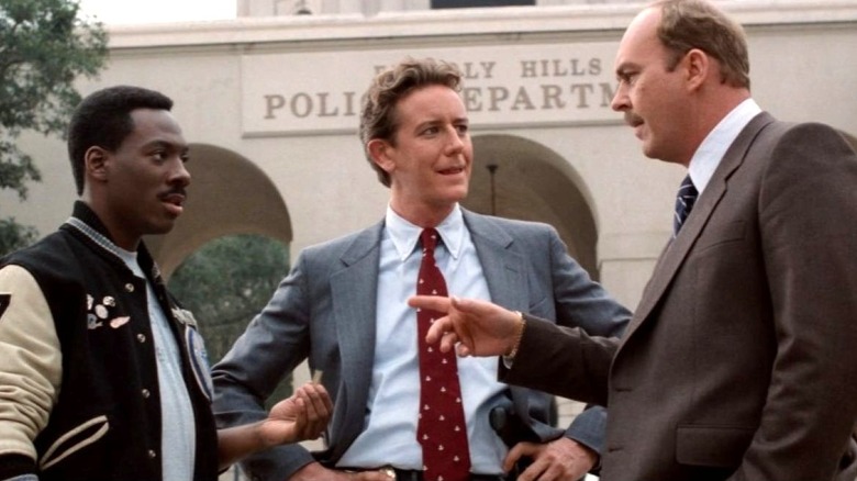 Axel Foley, Billy Rosewood, and John Taggart stand outside of the Beverly Hills Police Department in Beverly Hills Cop II (1987)