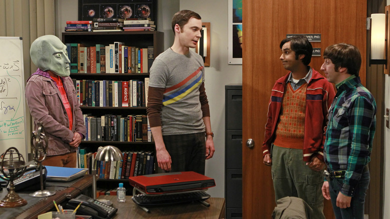 Leonard wearing a mask and Sheldon talking to Raj and Howard on The Big Bang Theory