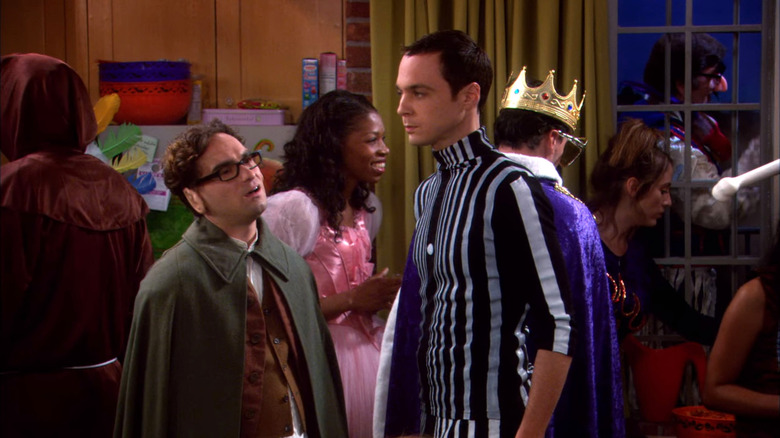 Leonard in a hobbit costume looking up at Sheldon at a Halloween party on The Big Bang Theory