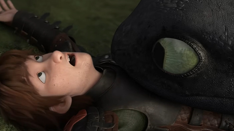 Toothless lying on top of Hiccup in How to Train Your Dragon 2