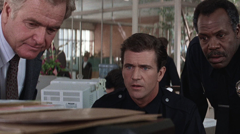 Riggs and Murtaugh look at a computer in 'Lethal Weapon 3' (1992)