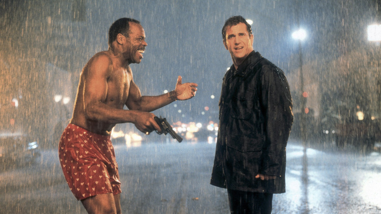 Riggs and Murtaugh stand in the rain in 'Lethal Weapon' (1998)
