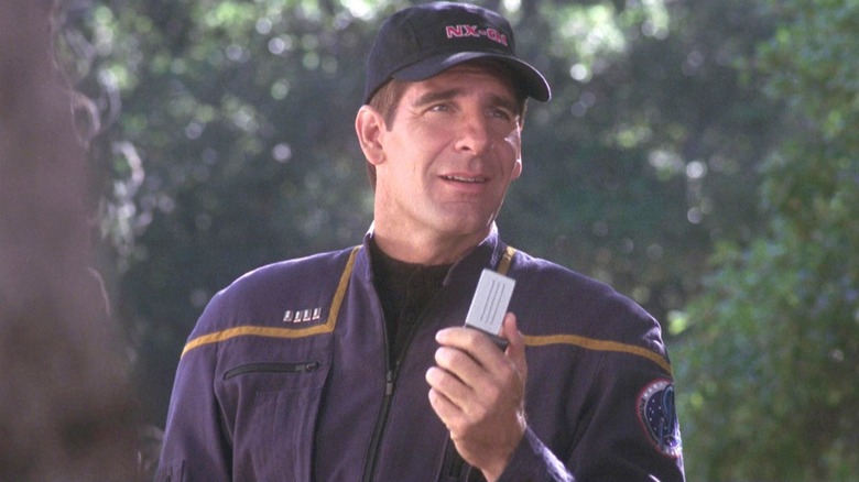 Captain Jonathan Archer stands in a forest with a comm on Star Trek Enterprise (2001 - 2005)