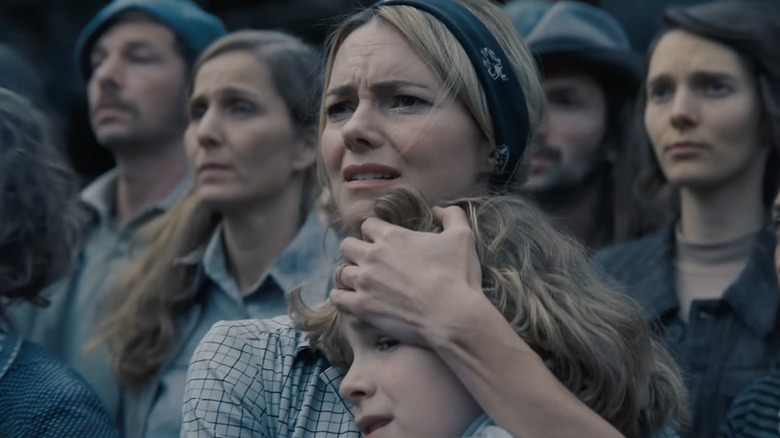 Willamae holding Sid to her chest in The Hunger Games: Sunrise on the Reaping
