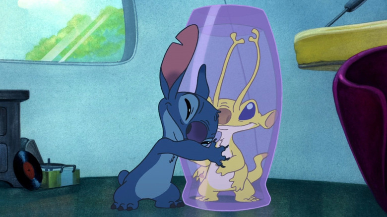 Stitch hugging a glass case holding Sparky in Stitch! The Movie