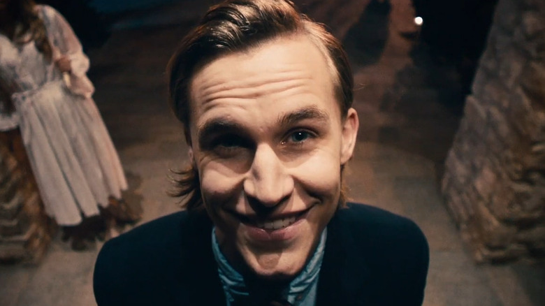 Polite Leader smiling at the Sandin's doorbell camera in The Purge