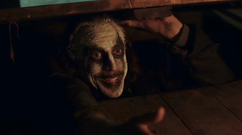 Peter Pan coming up through the floorboard in Peter Pan's Neverland Nightmare